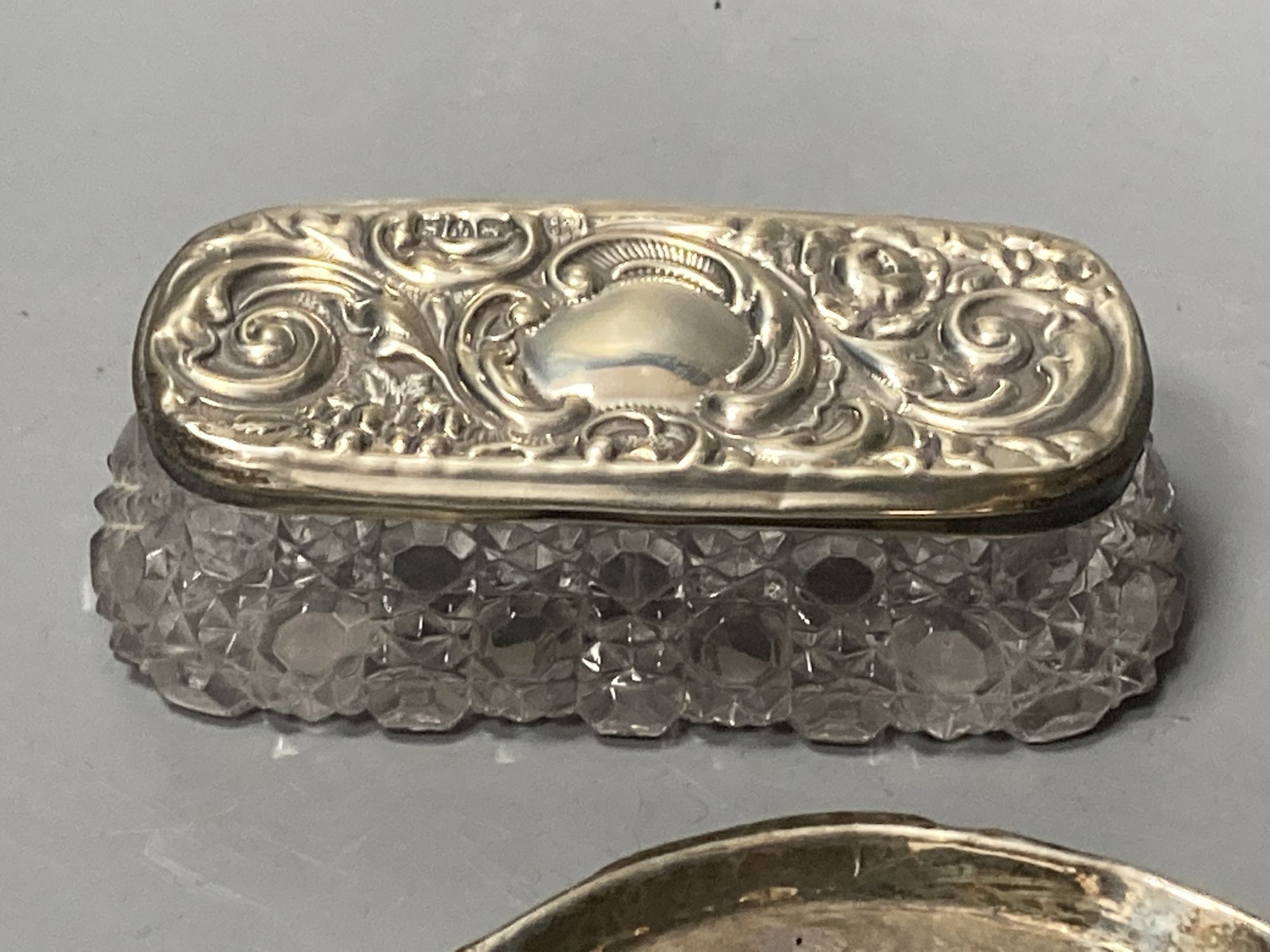 A silver cigarette box, silver cigarette case, four vestas including two silver, a continental dish and a toilet jar.